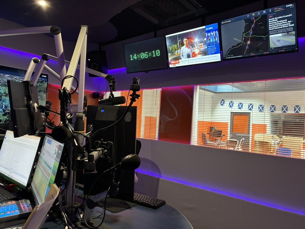 Clock, news channel and traffic boards across the studio eyeline